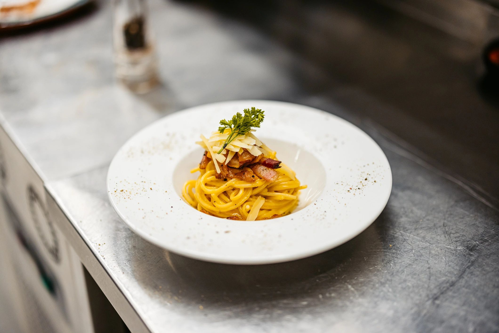 Close-up of creamy pasta dish prepared in a kitchen
